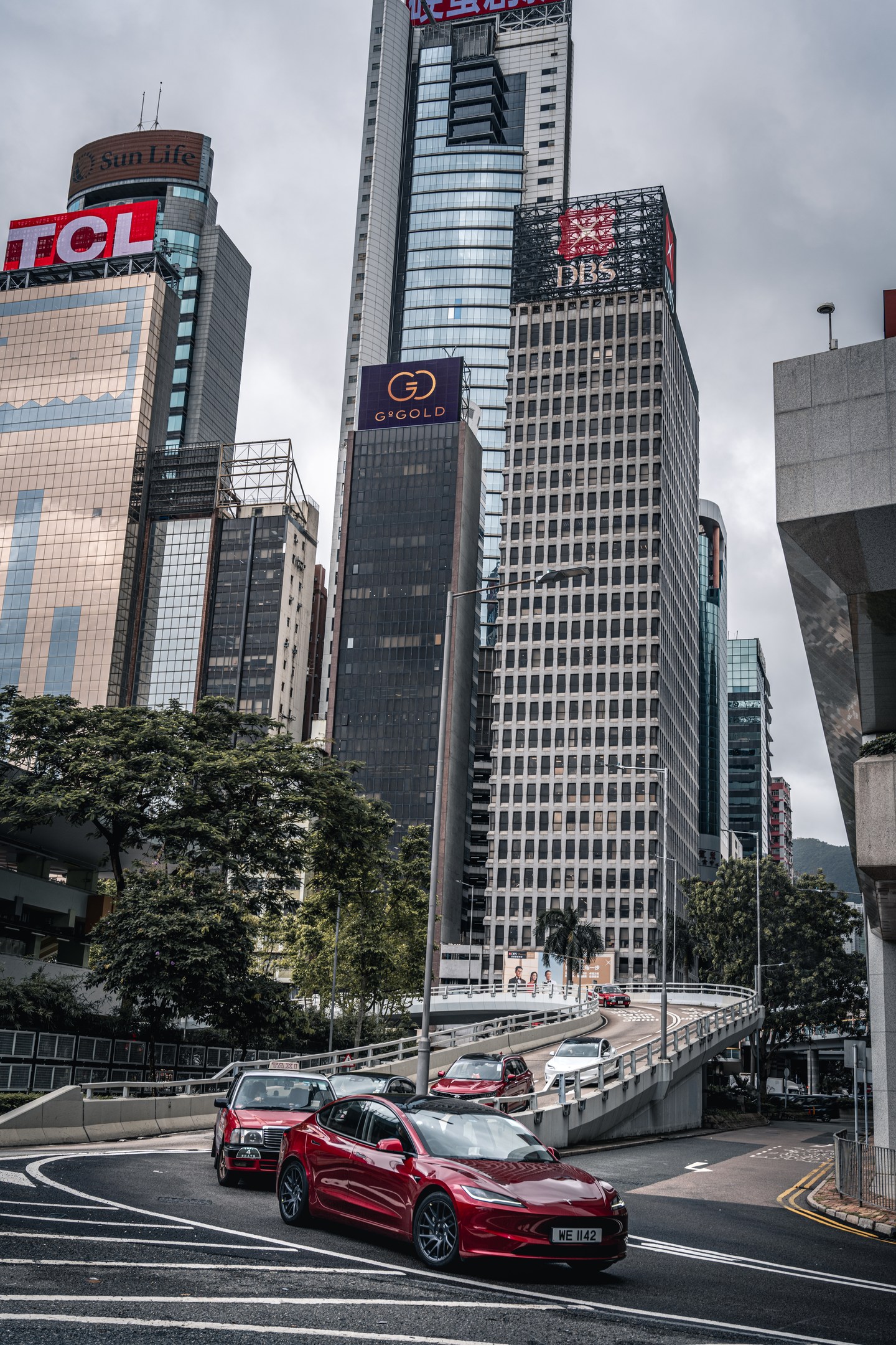 A red taxi passing through a Hong Kong intersection