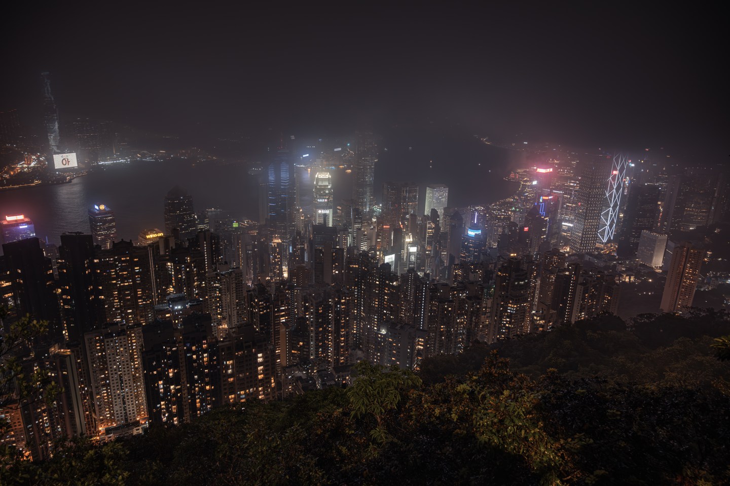 Hong Kong towers emerging through night-time haze