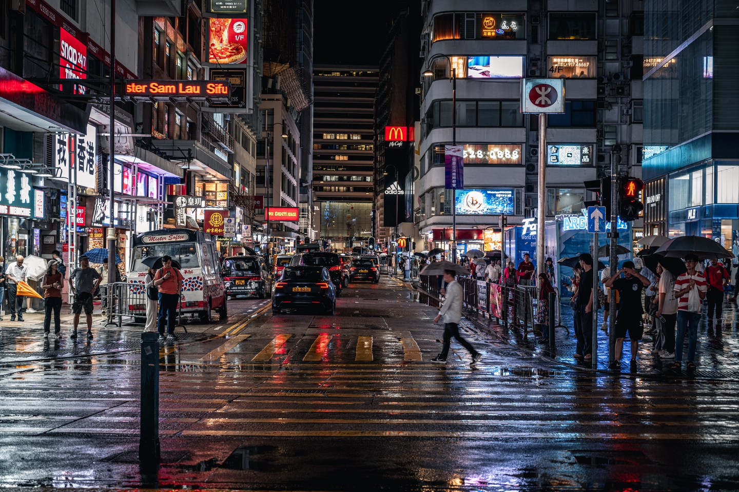 Neon signs and reflections on a wet Hong Kong street