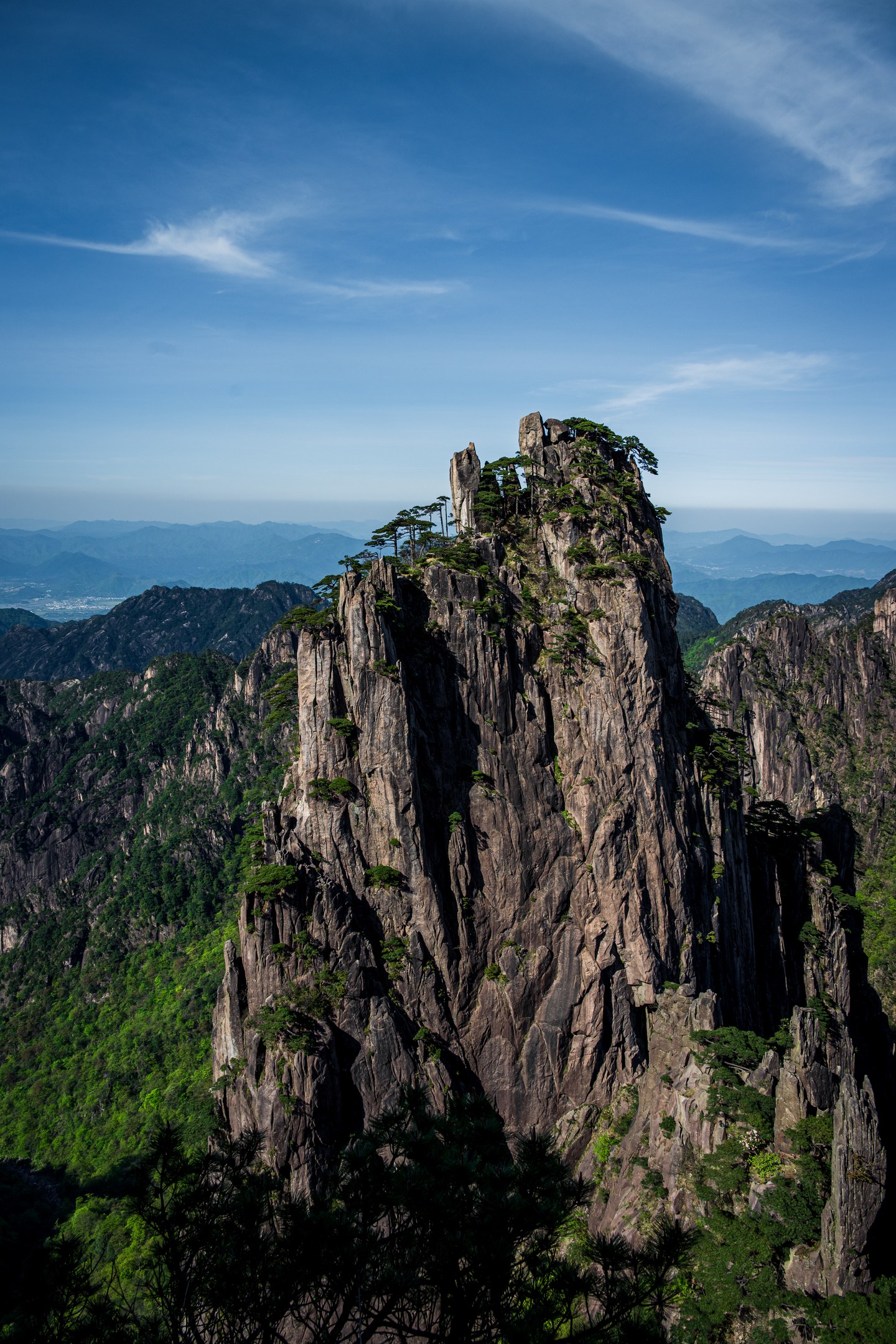 A tall pine-covered granite peak in Huangshan