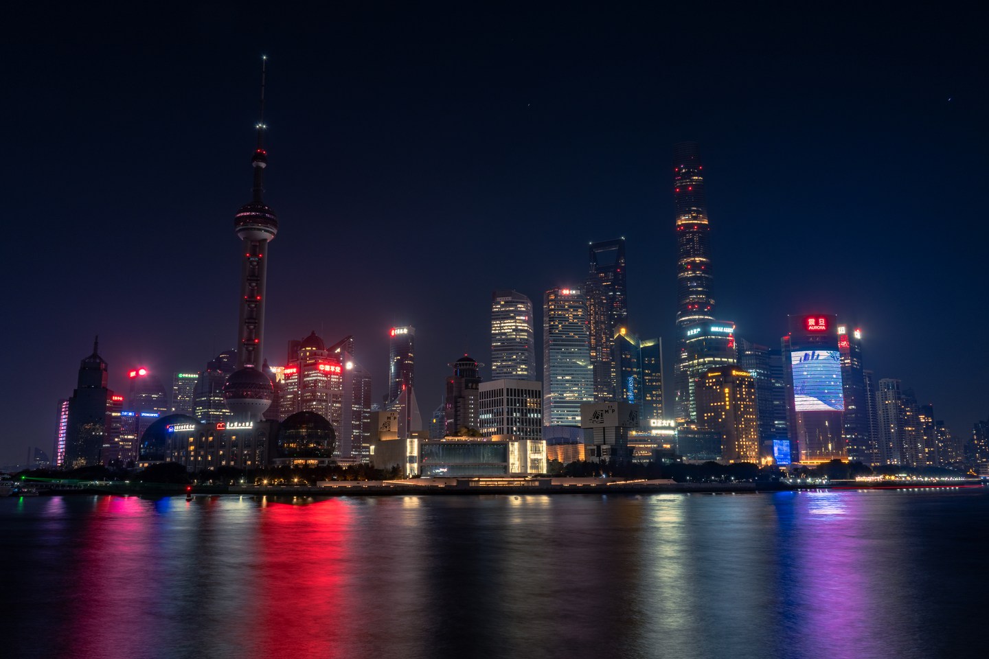 The illuminated Pudong skyline reflected in the Huangpu River