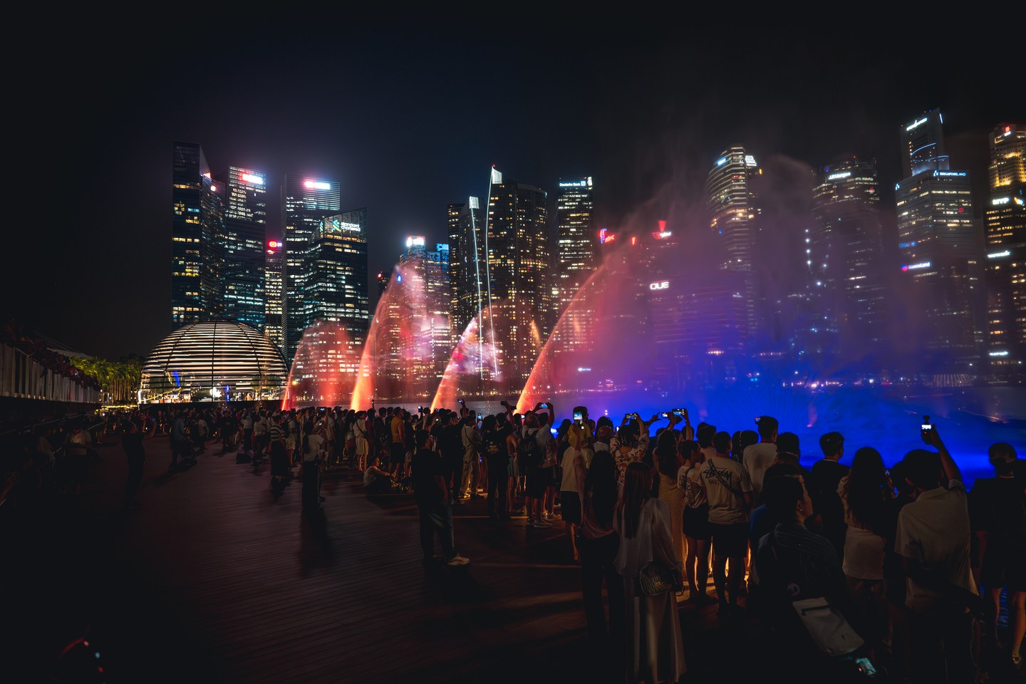 Warm-coloured fountains beneath the Singapore skyline