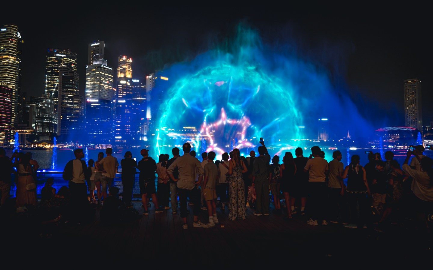 Blue light illuminating a fountain show at Marina Bay