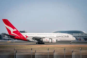 A Qantas Airbus A380 beside the runway at Changi Airport, Singapore