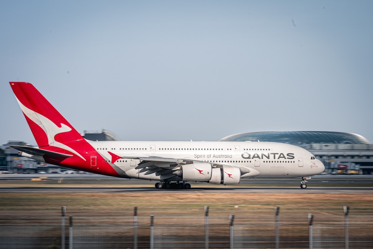 A Qantas Airbus A380 beside the runway at Changi Airport, Singapore